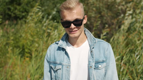 young man in jeans jacket and sunglasses