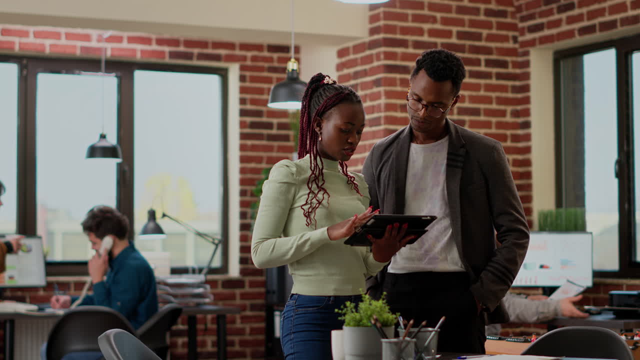 African american workers analyzing charts information on papers