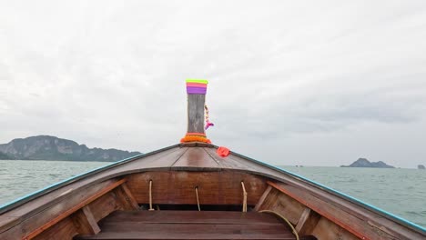 boat travels through ocean towards distant islands