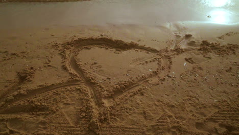 Panning-from-heart-symbol-on-sand-to-seascape-view.-Sea-beach-with-heart-shape