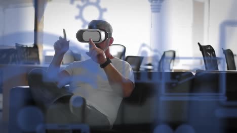 multiple digital icons floating against caucasian senior businessman wearing vr headset at office
