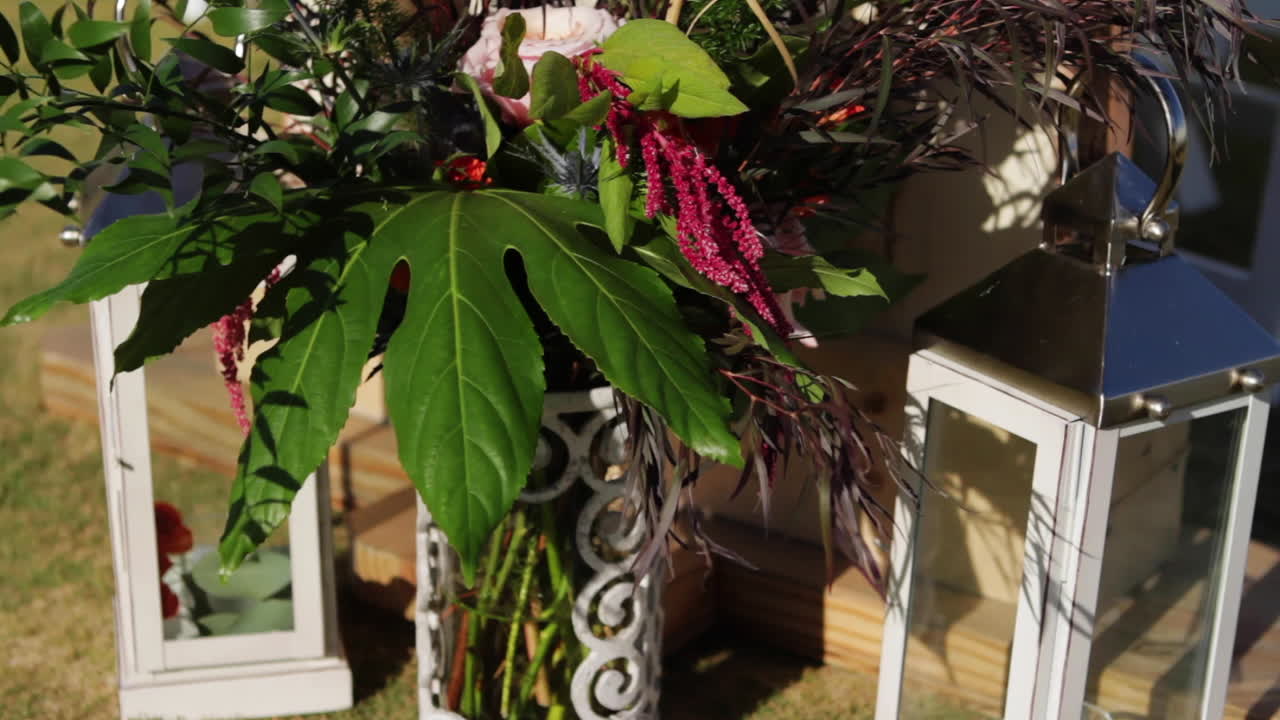 Floral arrangement in a vase with lanterns