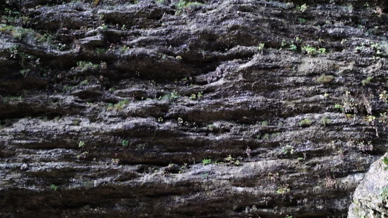 The beautiful waterfall of Pericnik Waterfall in Slovenia. Slow motion footage of the water running off the wall looking like rain coming down from the waterfall