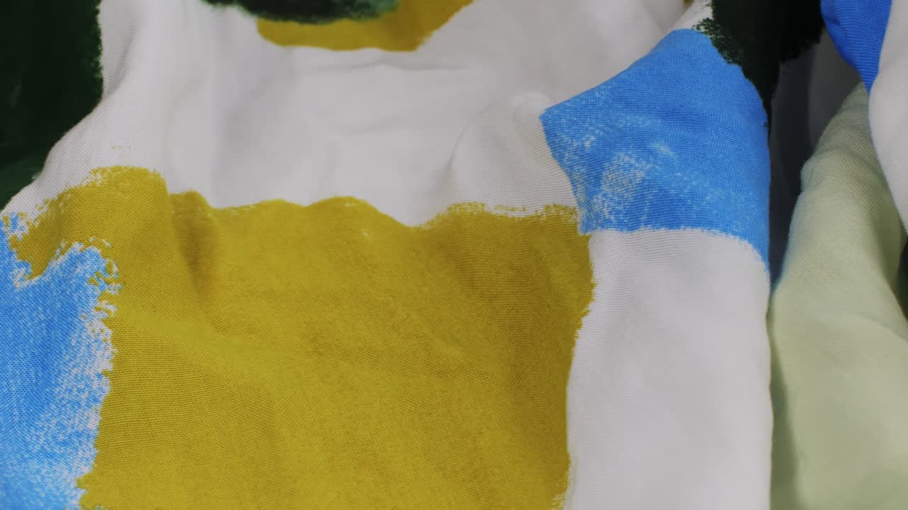 Colorful textile cloth texture close-up macro. Print clothes. Fashion fabric multicolor.