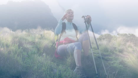 happy caucasian senior woman resting while hiking in mountains, over fast moving clouds