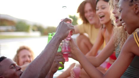 happy diverse friends with drinks cheering in pool in slow motion