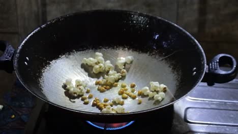 popcorn explodes in the pan. hd videos