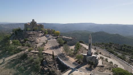 Statue-of-Nuestra-Senora-de-la-Cabeza,-Spain-hilltop-shrine-Andalusía-mountains-AERIAL