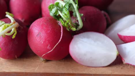 fresh red radishes on a cutting board