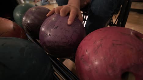 two young disabled men in wheelchairs playing bowling in the club