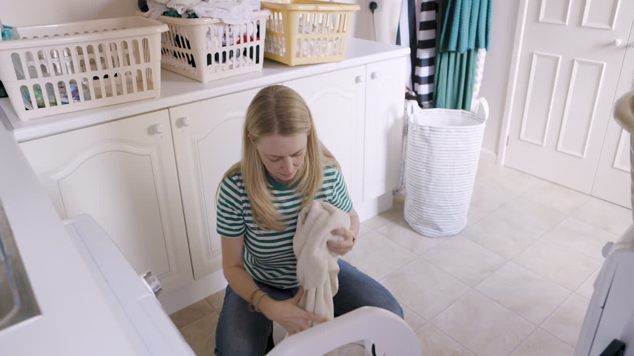 Woman doing laundry in laundry room