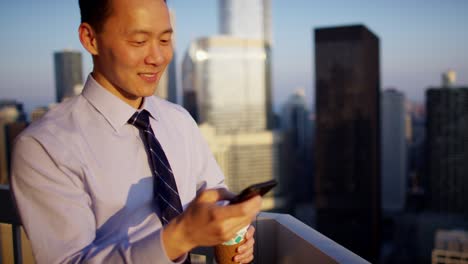 asian business male advisor using touchscreen on rooftop