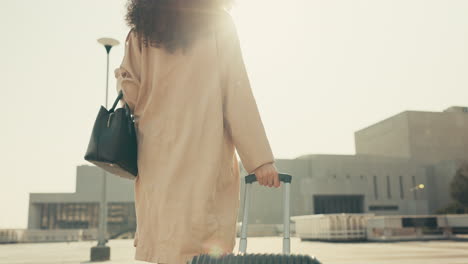 woman, back and walking with luggage for business