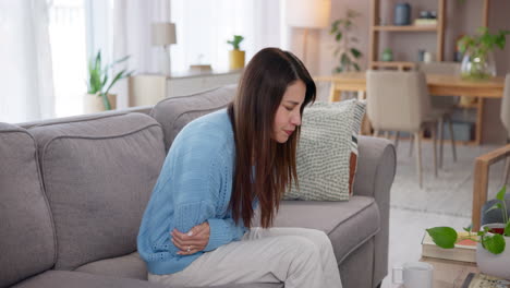 woman holding her stomach in pain