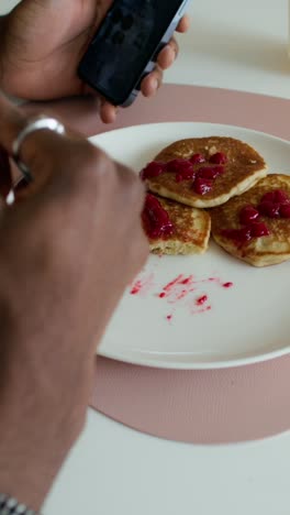 taking a picture of pancakes with jam