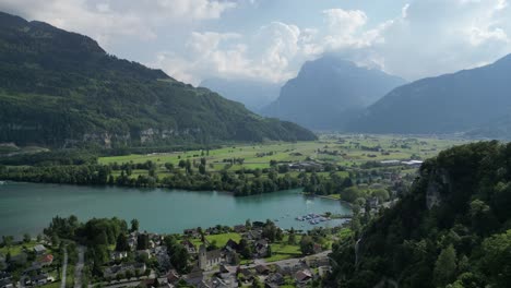 Aerial-shot-of-residential-area-near-Klöntalersee-great-lake,-Glarus-Canton,-Switzerland