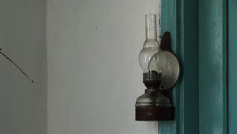 An-old-kerosene-lamp-on-the-wall-of-an-ancient-Ukrainian-house