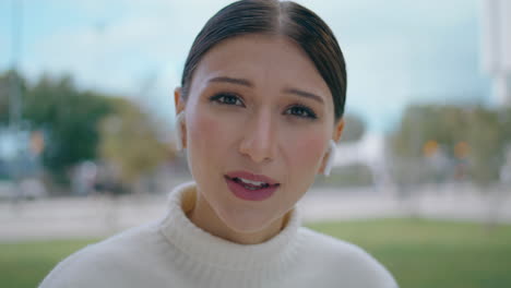 Smiling-blogger-recording-vlog-talking-camera-closeup.-Woman-in-earbuds-talking.