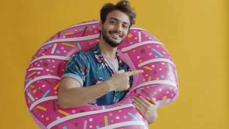 man with donut inflatable swimming ring