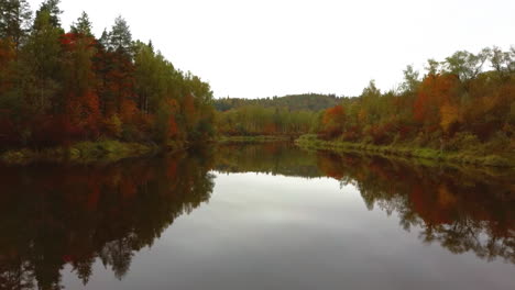 Autumn-Landscape-View-of-the-Gauja-River-by-Forests-Colorful-Bright-Yellow-Orange-and-Green-Trees,-Sunny-Day