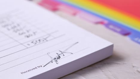 close-up of a hand signing a document