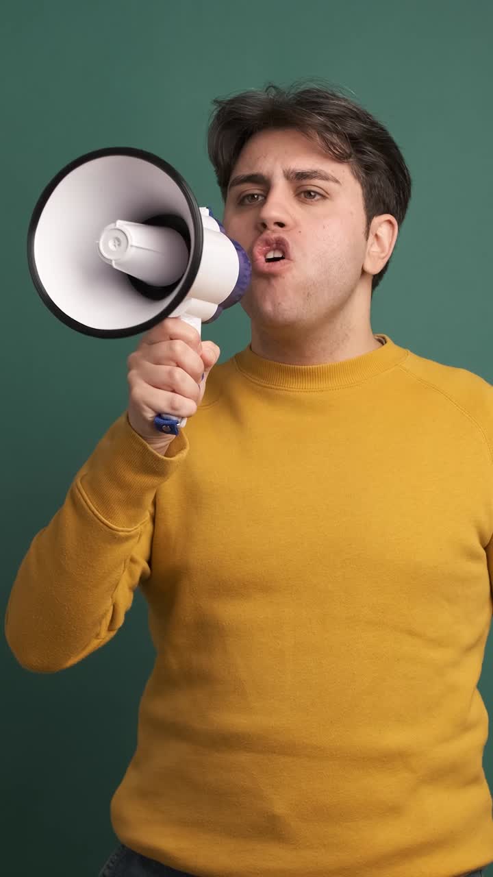 Upset caucasian man yelling using a loudspeaker