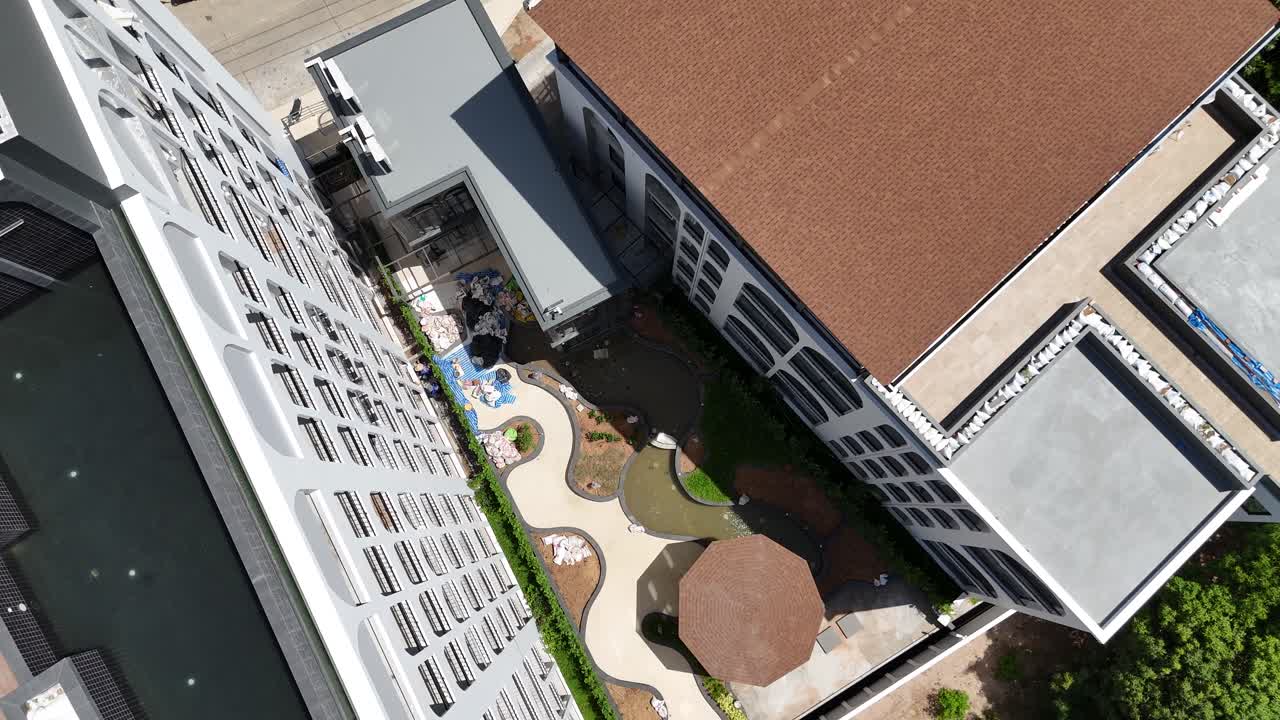 Aerial view of a modern residential complex with a landscaped garden area