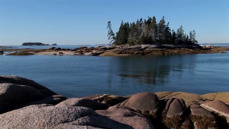 A-sailboat-is-at-anchor-in-a-bay-offshore-a-lobster-village-in-Stonington-Maine-1