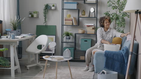 woman doing laundry in a living room