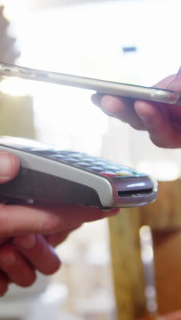 woman making payment through smartphone