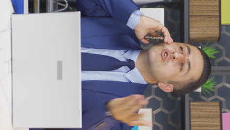 Vertical-video-of-Businessman-making-angry-and-aggressive-call-on-the-phone.