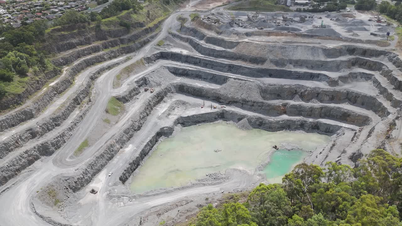 Large quarry with terraced rock formations and water