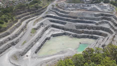 large quarry with terraced rock formations and water