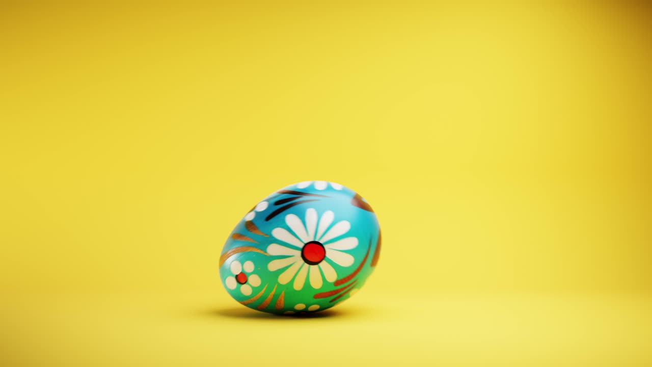 Decorated Easter Egg Rolling and Spinning on Yellow Background