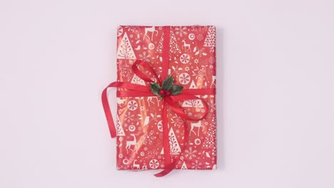 christmas red gift with red ribbon move in circle on white theme. stop motion