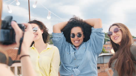 friends celebrating on a rooftop taking