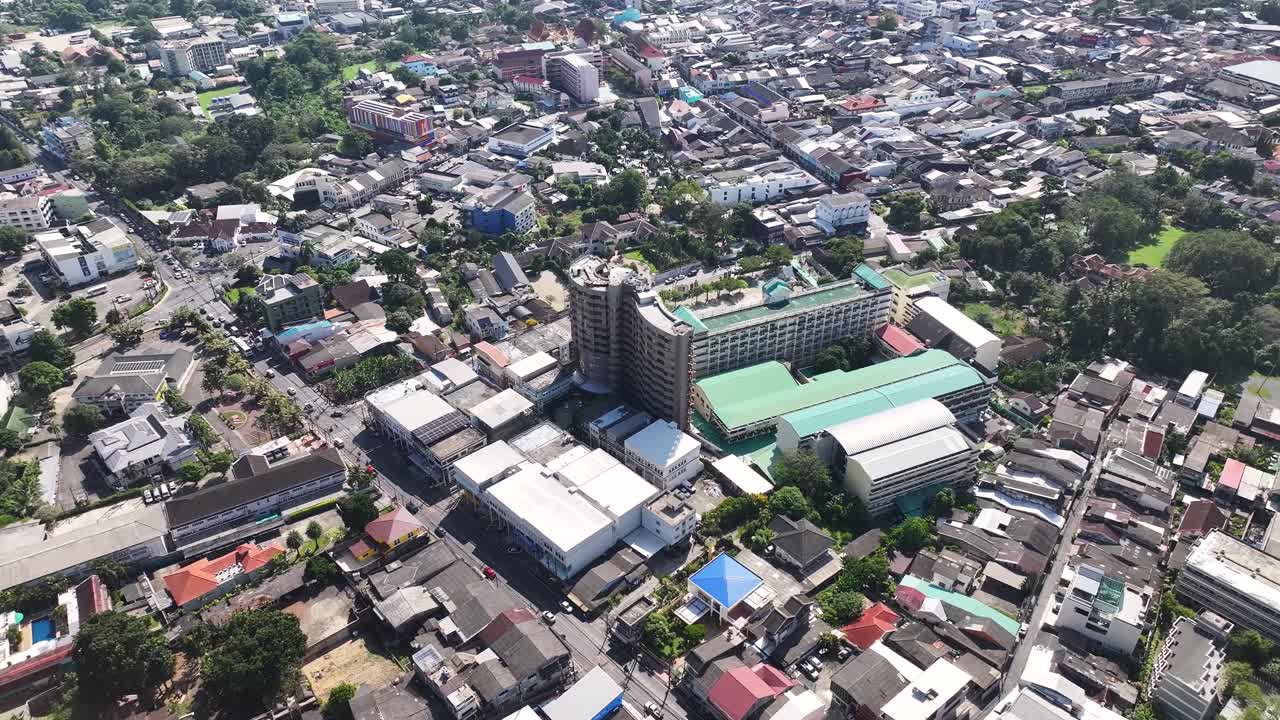 School and hotel buildings, streets of Phuket city, Thailand. Drone cityscape, sunny day.