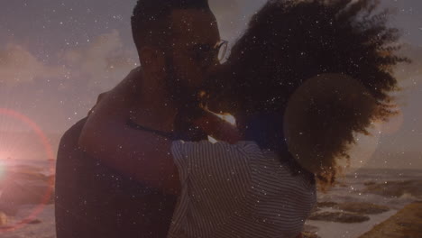 embracing couple kissing with starry sky animation overlay at sunset