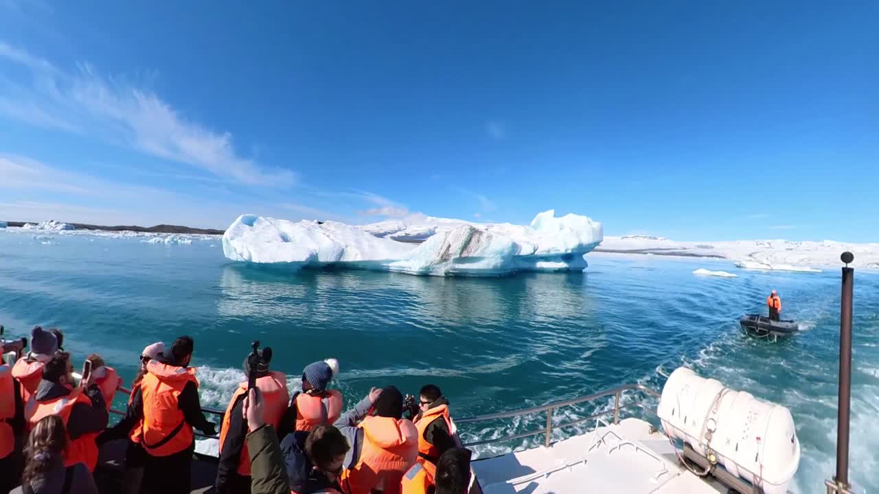 People witness the stunning natural beauty of Iceland, showcasing its floating icebergs and snow-covered mountains.