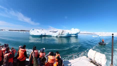 people witness the stunning natural beauty of iceland, showcasing its floating icebergs and snow-covered mountains.