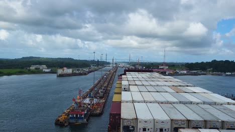 a huge container vessel carefully maneuvers through the intricate lock system of the panama canal, a monumental feat of engineering essential for global maritime trade.