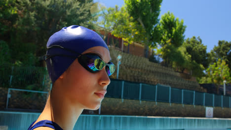 female swimmer standing near poolside 4k