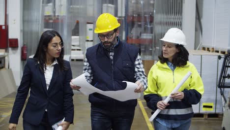 Concentrated-factory-workers-discussing-new-project