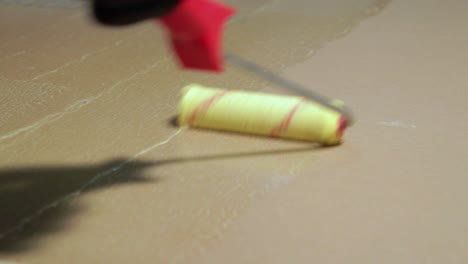 worker paints bathroom floor with hydro isolation before tiling