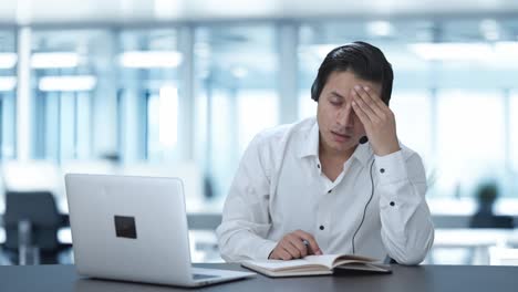 stressed indian call center employee trying to understand customer