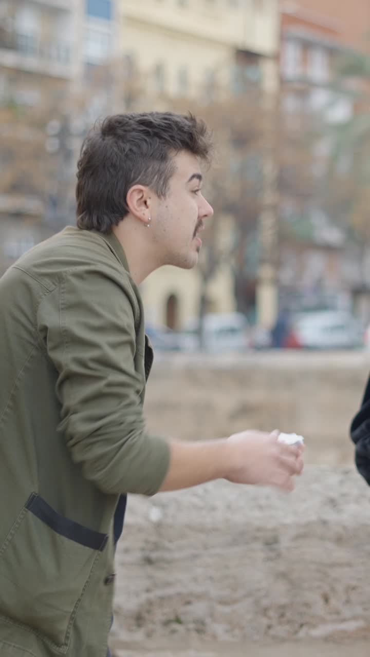 Man Performing a Card Trick Outdoors
