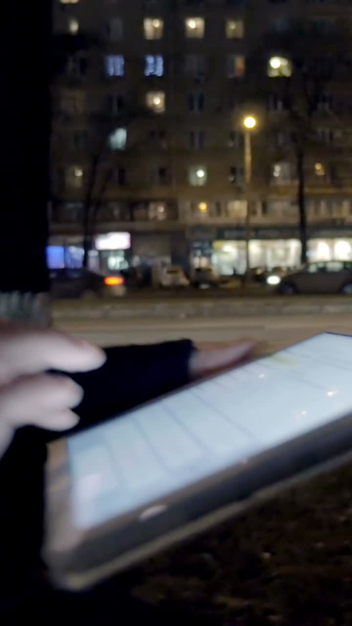 Night city scene with tablet