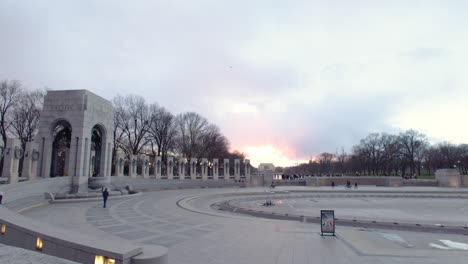 People-walking-in-the-World-War-II-Memorial-in-Washington,-DC-during-sunset