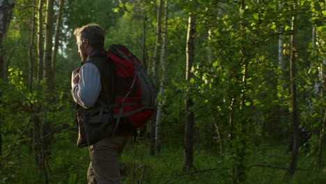 Tourist-Couple-Hiking-In-Forest-At-Sunset