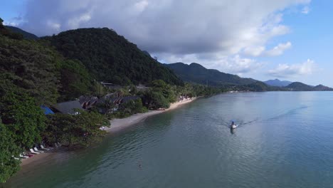 Majestic-aerial-top-view-flight-boat-shade-on-the-beach